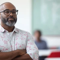 u8423752695_Black_teacher_in_front_of_the_white_table_and_adu_58b89d36-6045-4f1e-a120-e2b015a72b7b_3